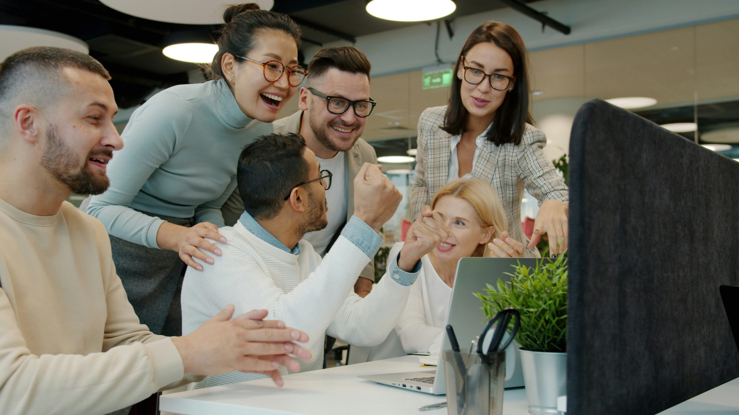 Diverse team celebrating success at the office
